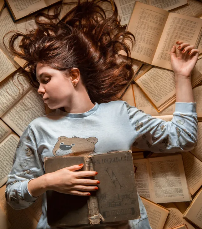 A girl lying down with the books